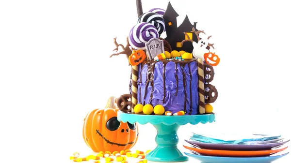 On trend Halloween candyland novelty drip cake on white background. — Stock Photo, Image