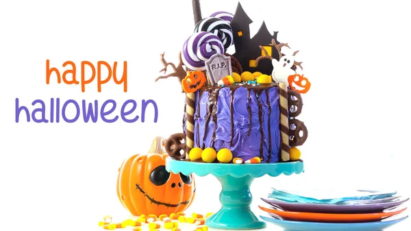 On trend Halloween candyland novelty drip cake on white background with text. — Stock Photo, Image