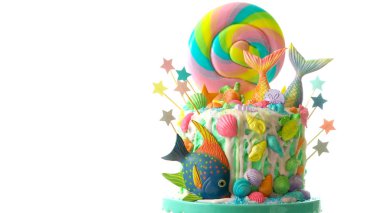 Mermaid theme candyland cake with glitter tails, shells and sea creatures. clipart