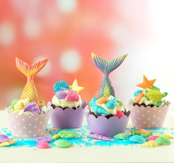 Mermaid theme cupcakes with colorful glitter tails, shells and sea creatures. — Stock Photo, Image