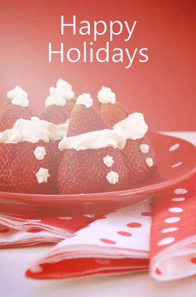 Christmas treats Strawberry Santas on red and white theme table. — Stock Photo, Image