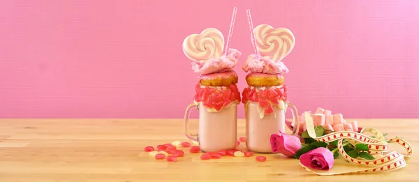 Valentines Day freak shakes with heart shaped lollipops and donuts. — Stock Photo, Image