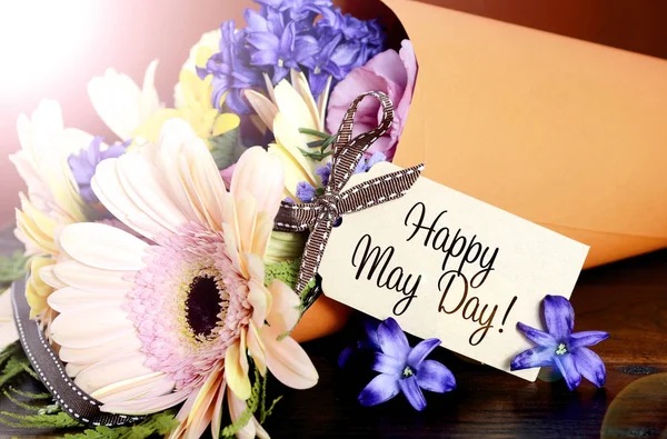 Happy May Day traditional gift of Spring Flowers with lens flare. — Stock Photo, Image