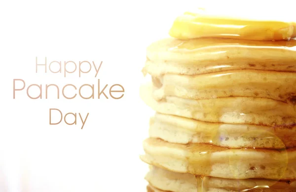 Stack of pancakes closeup with greeting text and lens flare. — Stock Photo, Image