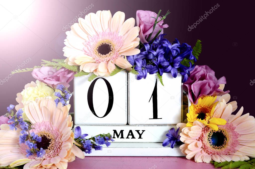 Happy May Day calendar with flowers with lens flare.