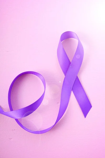 International Womens Day Purple Ribbon Symbol woth lens flare — Stock Photo, Image