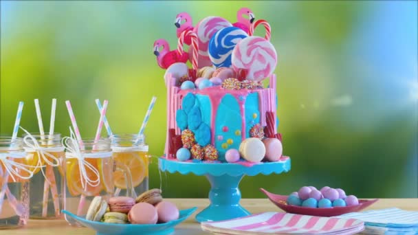 Candy-land flamingos birthday drip cake, garden party setting, lensflare. — Stok Video