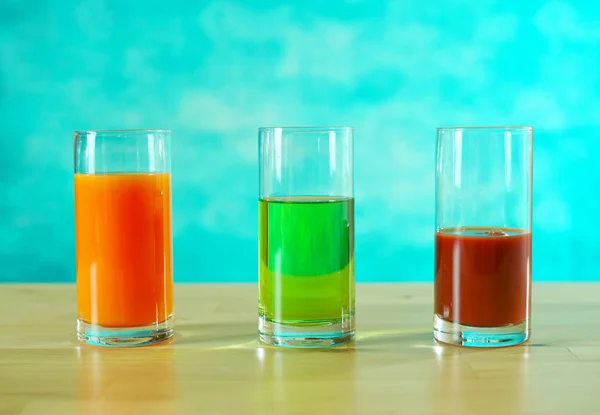 Fresh orange, apple and tomato juices in glasses. — Stock Photo, Image