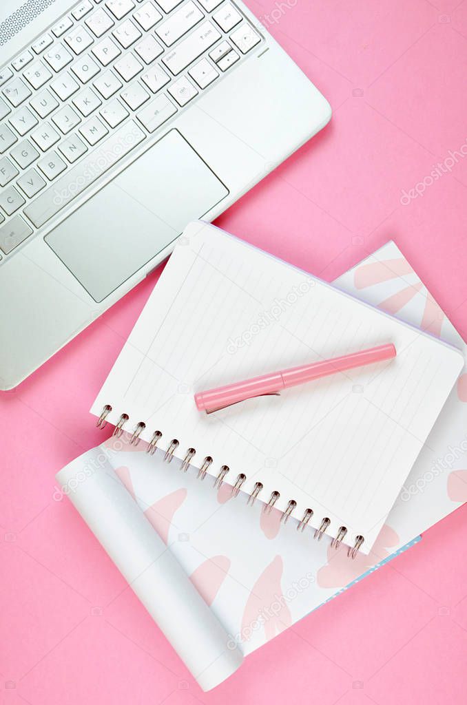 Ultra feminine workspace with touch screen PC overhead flat lay.