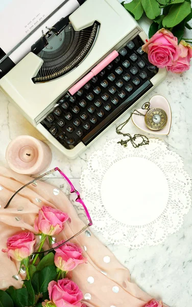 Romantic vintage writing scene with old typewriter overhead on marble table.