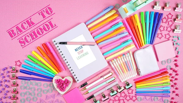 Back to school or workspace colorful stationery overhead on pink background. — Stock Photo, Image