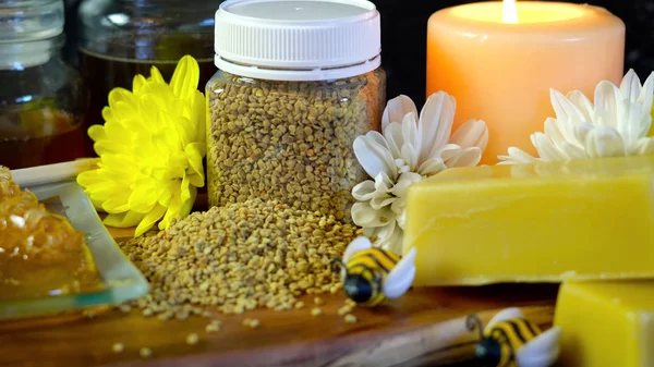 Honey and related products with closeup on jar of bee pollen.