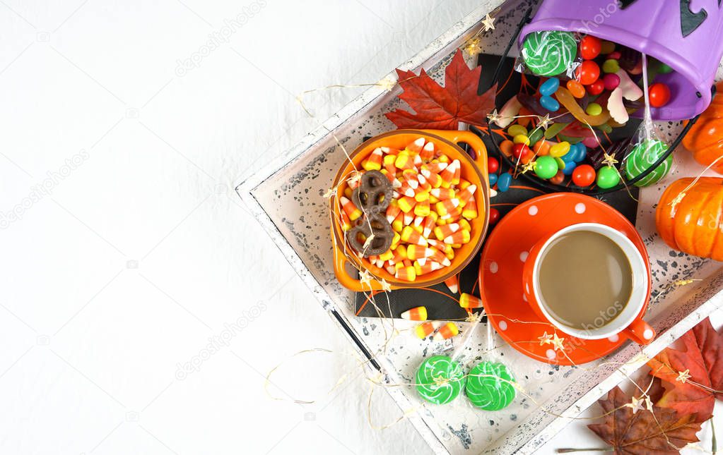 Halloween concept with tray of candy and treats, flat lay overhead.