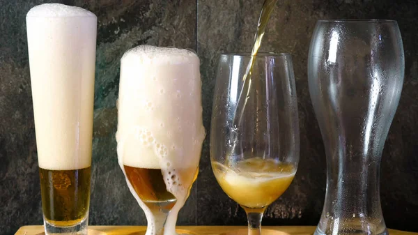 Pouring beer into traditional beer glasses, beer tasting.