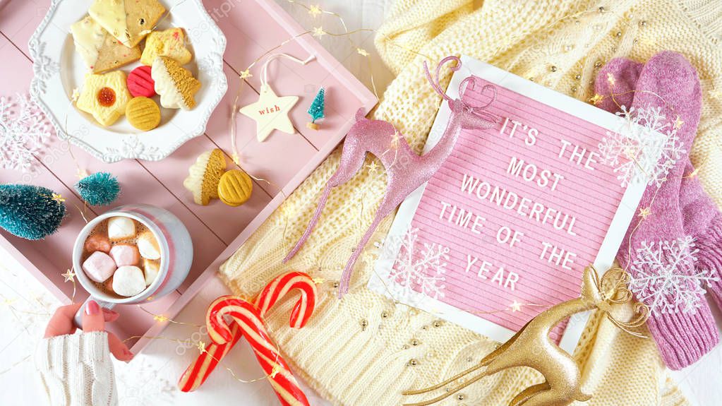 Cozy Christmas indoors tray of goodies with letter board flat lay overhead.