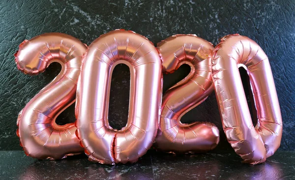 Παραμονή Πρωτοχρονιάς 2020 αριθμός μεταλλικά μπαλόνια σε μαύρο μαρμάρινο φόντο πίνακα. — Φωτογραφία Αρχείου