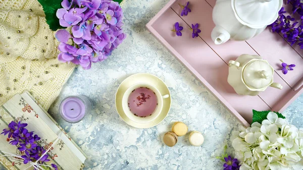 Relaxing at home with hygge style lavender tea, old books and cozy sweater. — Stock Photo, Image