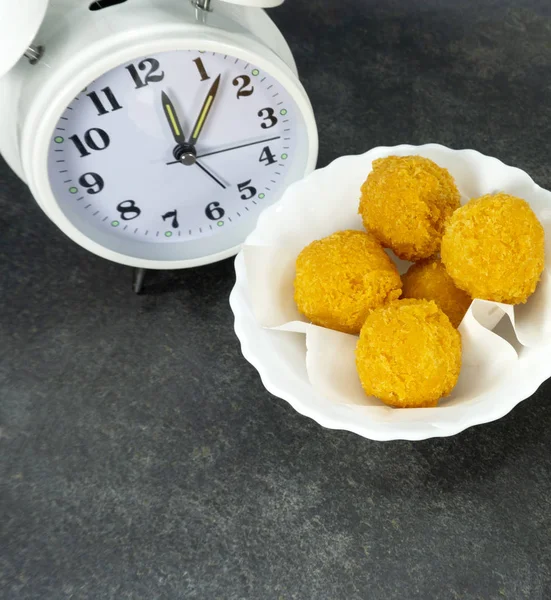 Rush hour eating lunch. cheese ball in a white dish on a stone floor table,Close up, Top view.with copy space for your text