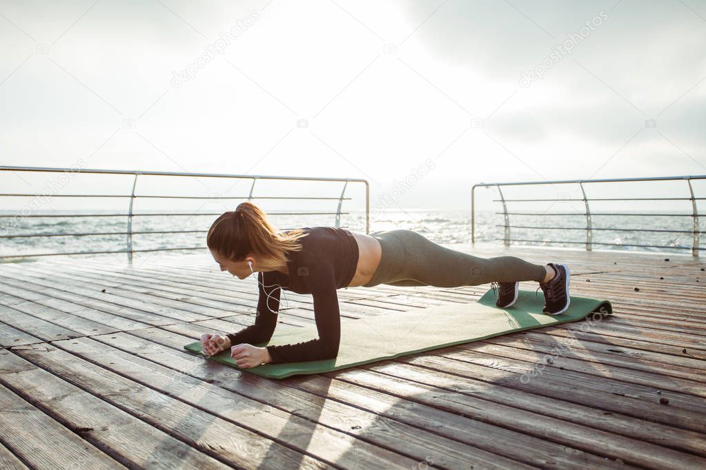Fitness woman doing push ups Outdoor training workout
