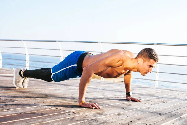 Young man fitness training outdoors