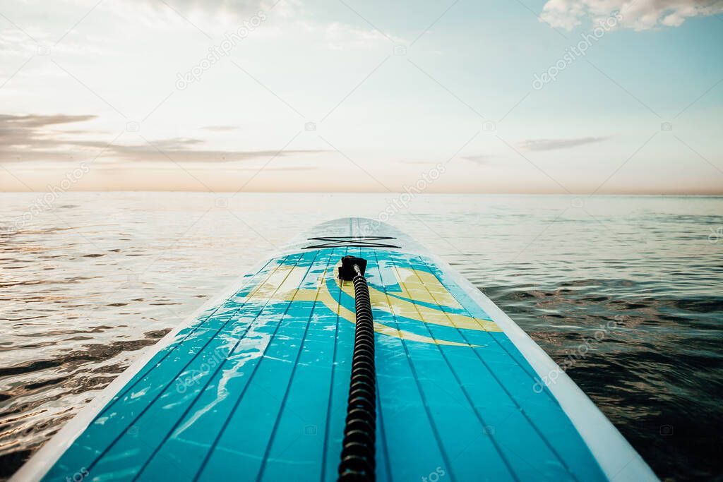 Nose of stand up paddle board floating on a beautiful lake