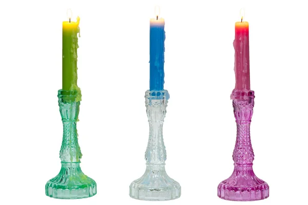 Tres velas encendidas en candelabros de vidrio —  Fotos de Stock