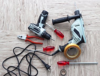 Tools for repair, screwdriver, electric drill, electro-screwdriver, electrical tape. Construction site