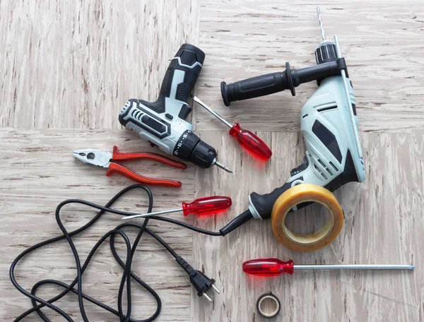 Tools for repair, screwdriver, electric drill, electro-screwdriver, electrical tape. Construction site