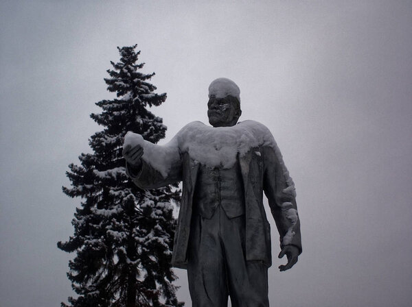 statue of Lenin in the snow against the cloudy sky, Moscow