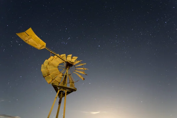 An iconic Australian windmill with a night sky in the background.
