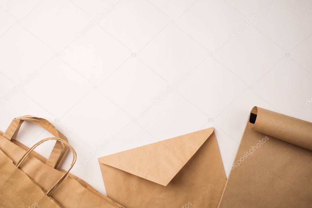 products made from recycled kraft paper: packages, envelope and notebook. concept: environmental protection, recycling business. top view, copy space