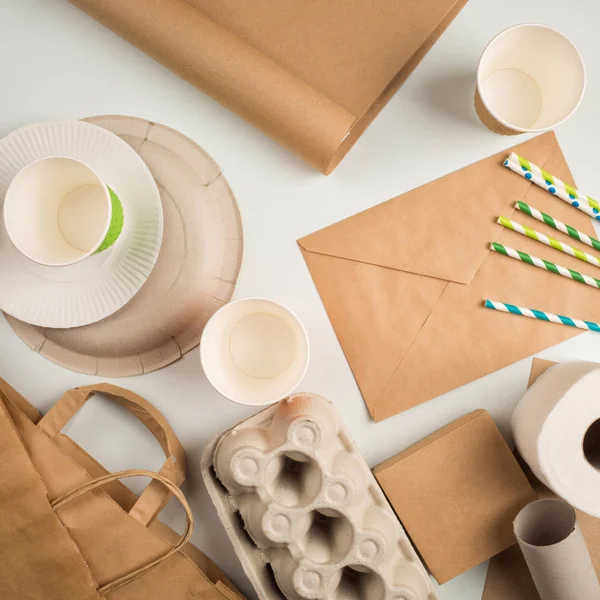 wastepaper and products made from recycled paper: disposable tableware, package, box, cardboard, egg packaging, envelope, toilet paper. concept: environmental protection, nature conservation, recycle.