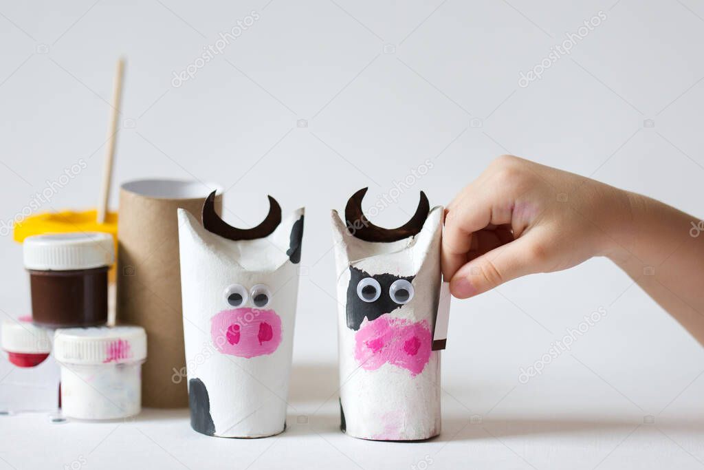 kid crafts bull from recycled materials. children's art. child create cow. diy.