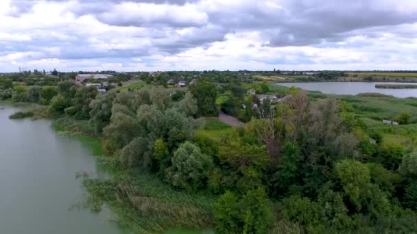 湖上的乌克兰村庄 有一只鸟的眼睛 无人机飞过湖面 附近是村里的私人住宅 夏季多云天气 — 图库视频影像