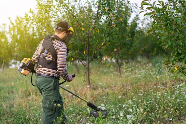 Jungbauer Gärtner Mäht Grasunkraut Auf Der Streuobstplantage Mit Trimmer Benzin — Stockfoto