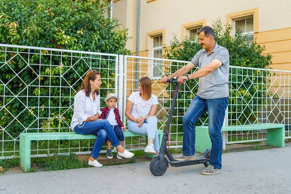 Senior Man Grandfather Riding Electric Kick Scooter While Passing His — Stock Photo, Image