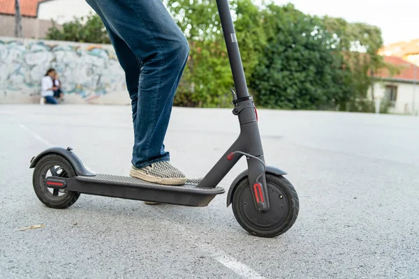 Close Senior Man Legs Jeans Riding Electric Kick Scooter Yard — Stock Photo, Image