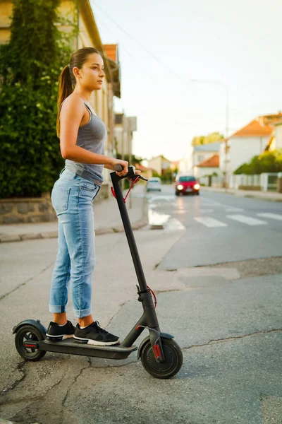 Young Woman Rides Electric Kick Scooter Street Waiting Crossroad Wearing — Stock Photo, Image