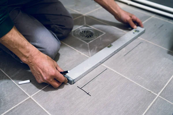 ガラスタイル保護壁装置の設置前に床にタイルを測定建設労働者 — ストック写真