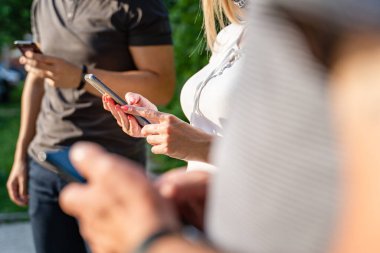 Cep telefonu kullanan kimliği belirsiz beyaz erkeklerin ellerini kapatın - Modern iletişim çevrimiçi mesajlaşma sosyal ağları - Orta bölüm erkek ve kadın cep telefonlarını açık havada tutuyor- sosyal mesafe