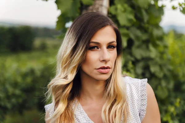 Front view on caucasian woman standing outdoor - Close up portrait of beautiful adult female in summer evening or day in nature - Real people contemplation solitude concept