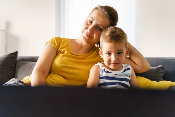 Small caucasian boy having video call online with his mother while watching content on laptop - Little child son sitting by his mom at home in front of the computer - childhood real people concept