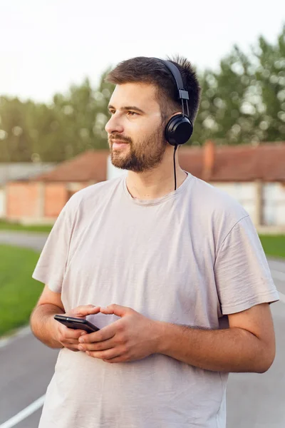 Akıllı Telefon Kulaklıklarla Koşu Pistinde Duran Bir Adam Yetişkin Beyaz — Stok fotoğraf