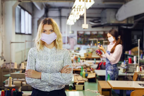 年轻的白俄罗斯女企业家站在缝纫工厂 大流行病期间 女工人设计师戴着防护面罩工作 新的正常危机衰退概念 — 图库照片