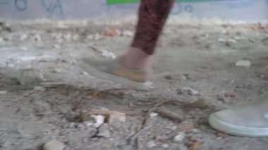 Yazın harabe bina ya da eve giren kimliği belirsiz beyaz bir kadının ayaklarına kapanır. 