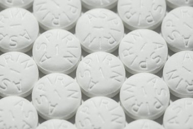 Macro shot of white aspirin pills clipart