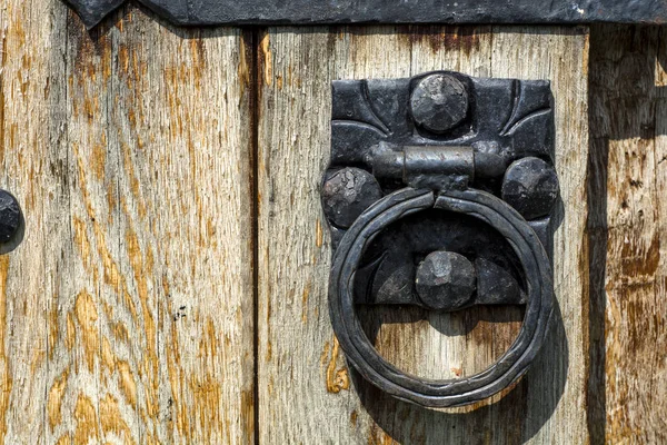 Old wooden door with aged metal door handle. Architect textured background