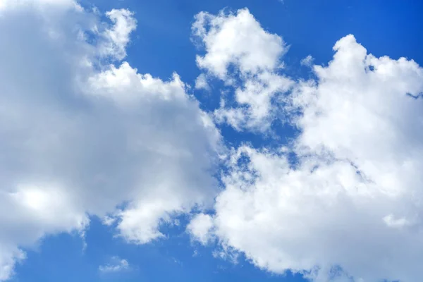 White clouds and blue sky on spring day. Natural background.Cumulus clouds type