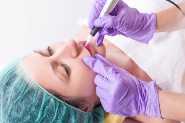 Profesyonel kalıcı makyaj güzellik stüdyosu kadın dudaklarında uygulayarak. Mikro pigmentasyon dudakları profesyonel aracı ile dövme güzellik uzmanı. Yakın, seçici odak