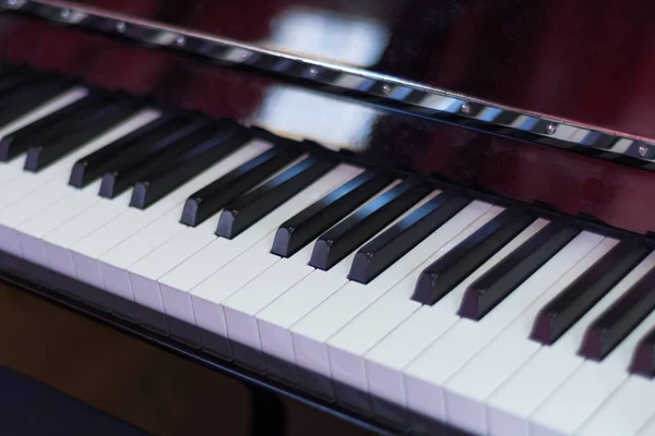 Classical piano keyboard black and withe and brown wood box, musical keys and instrument. Music concept background. Close up, selective focus